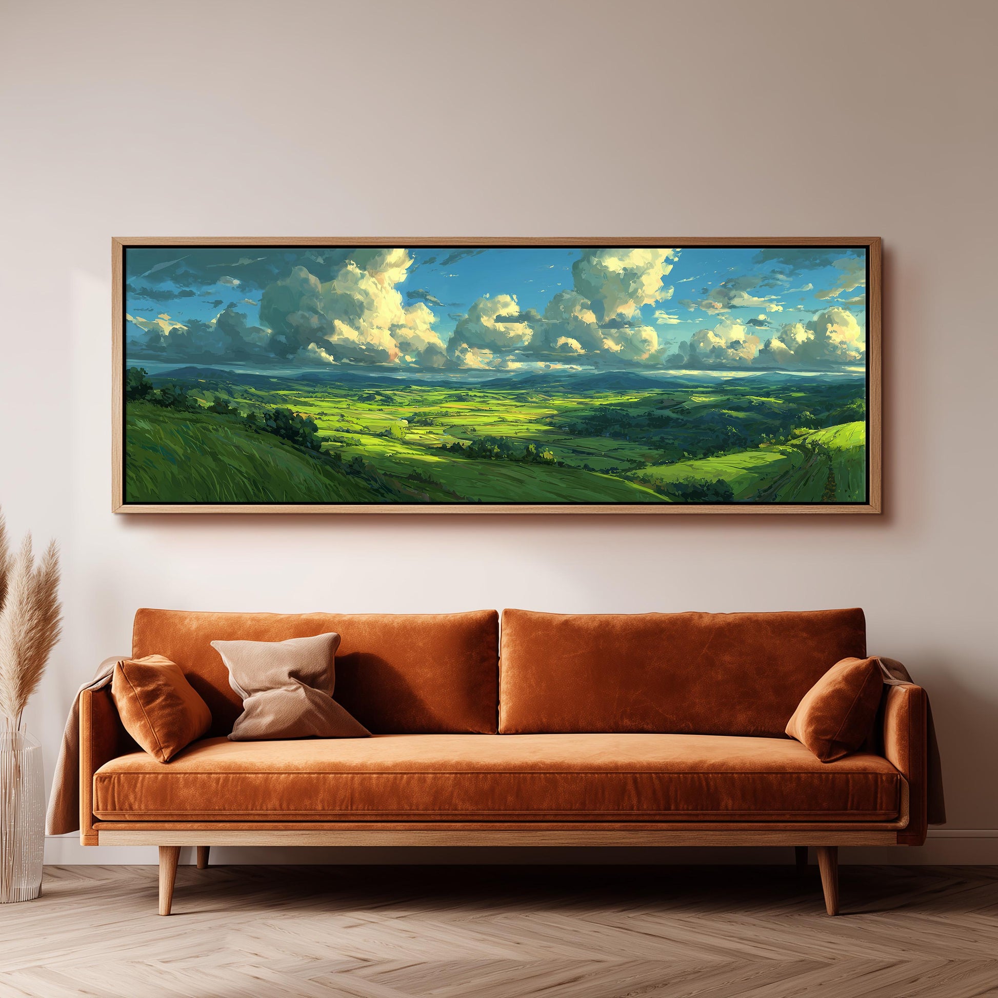 a large, framed painting of a countryside landscape hanging on a wall above a brown sofa.