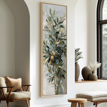 a large painting of a tree with green leaves and orange fruits hanging on a white wall in a living room setting.