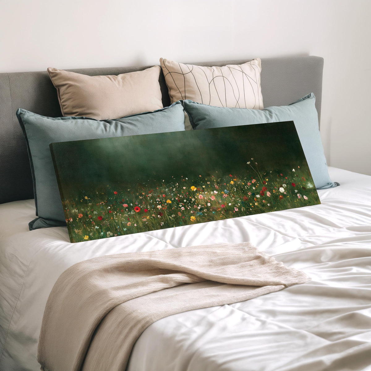 Wildflower meadow at the edge of a dark forest wide panoramic canvas print laid on a bed to show its size