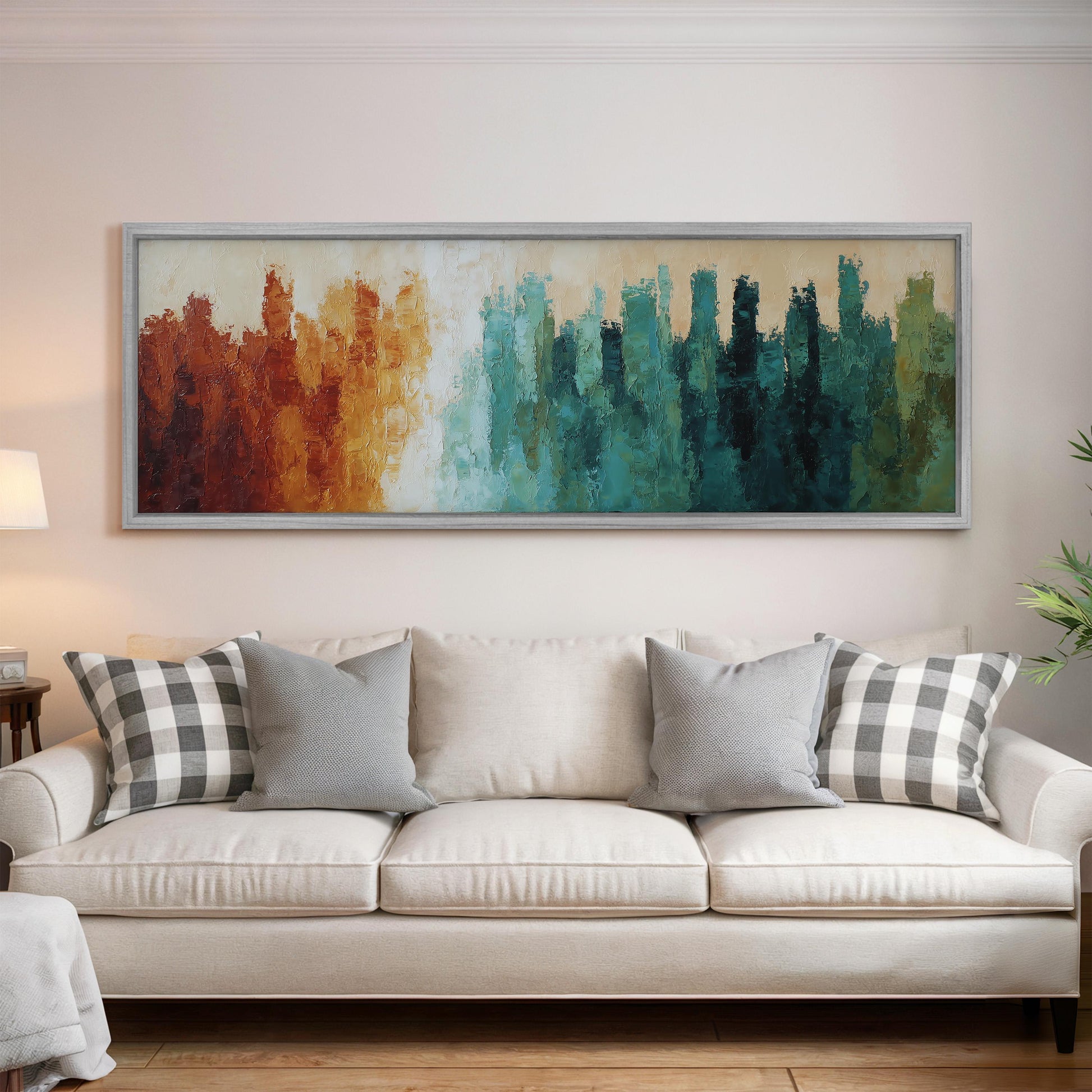 a large, colorful abstract painting hanging on a wall above a white couch with gray and black plaid throw pillows.