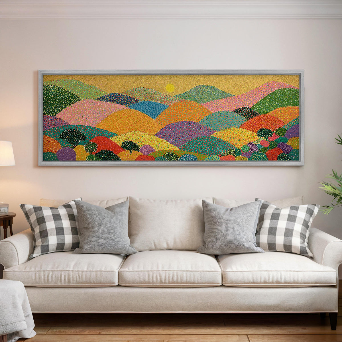 Dotted rainbow hills at sunset panoramic canvas print above a white sofa in a bright living room