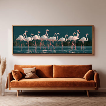 Blush pink flamingos on dark teal water long horizontal canvas print above a sofa in a living room