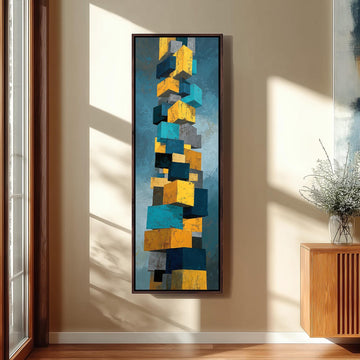 a large abstract painting hanging on a wall, depicting a tall structure composed of various geometric shapes in shades of blue, yellow, and gray.