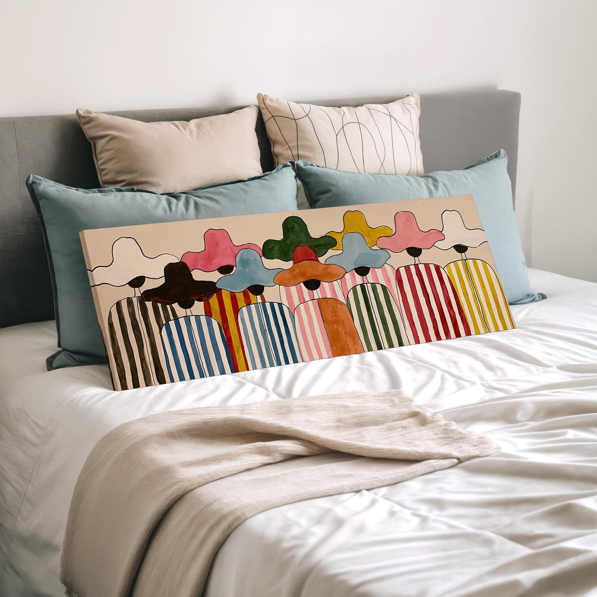Crowd of figures in colorful sun hats wide panoramic canvas print laid on a bed to show its size