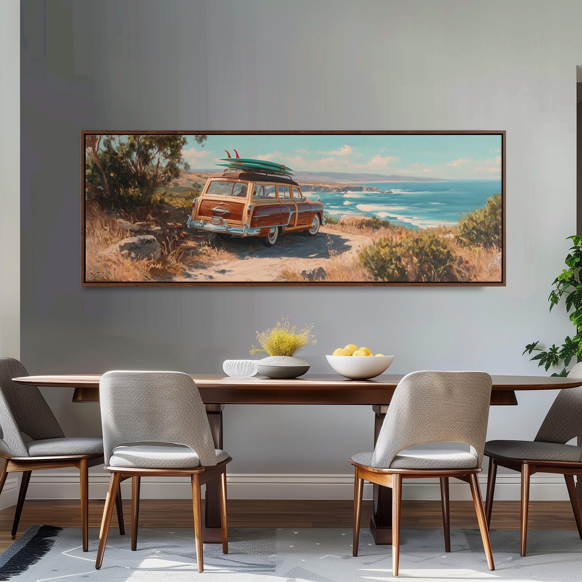 a large painting of a vintage station wagon with a surfboard on top, displayed on a wall above a wooden dining table with four chairs.