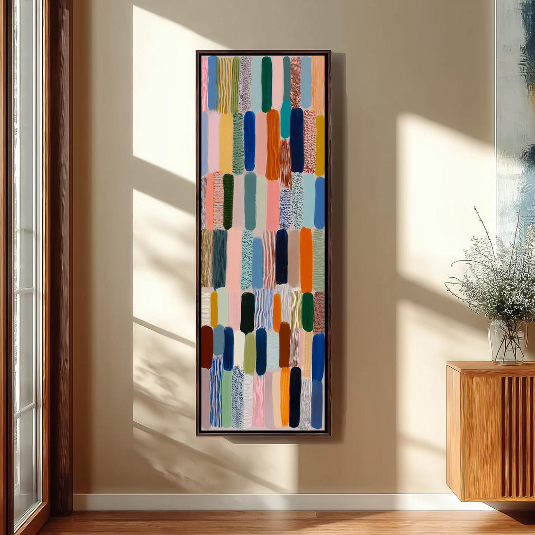 a large, colorful abstract painting hanging on a wall in a room with wooden furniture and a window.
