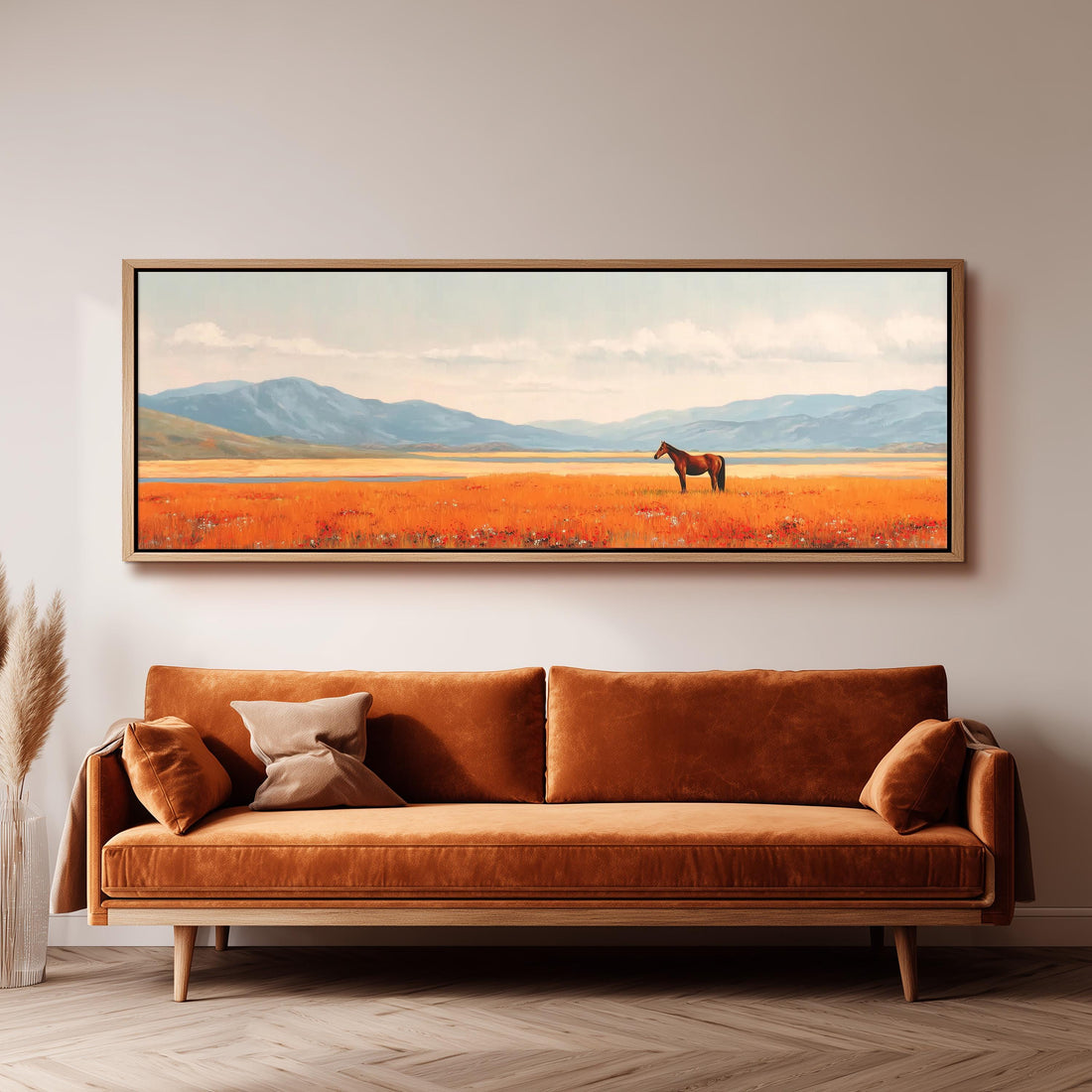 a large, framed painting of a horse in a field, hanging on a wall above a brown sofa.
