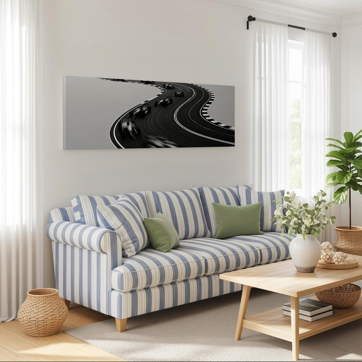 Winding race track in monochrome long horizontal canvas print above a striped sofa in a coastal living room
