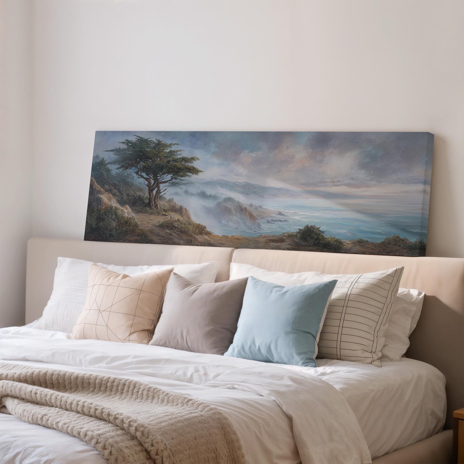 a large painting of a tree on a wall above a bed with white bedding and pillows.