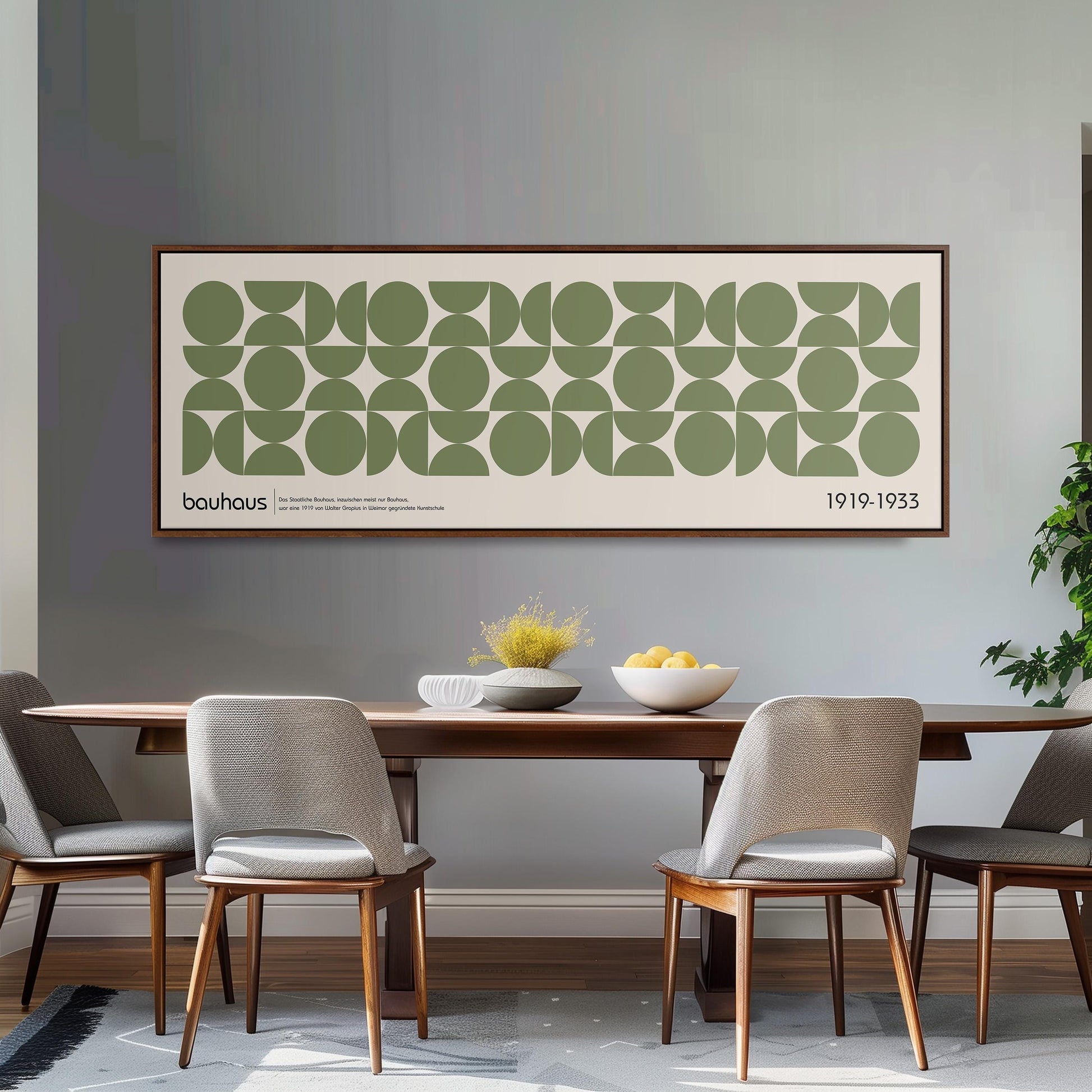 a dining room with a wooden table and four chairs, a large abstract art piece hanging on the wall above the table, and a bowl of fruit on the table.