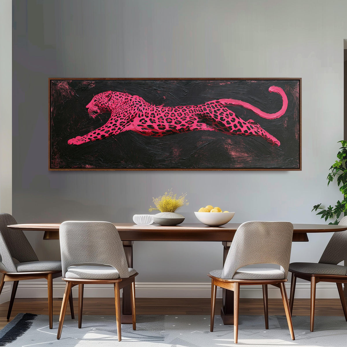 Pink leaping leopard long horizontal canvas print above a dining table