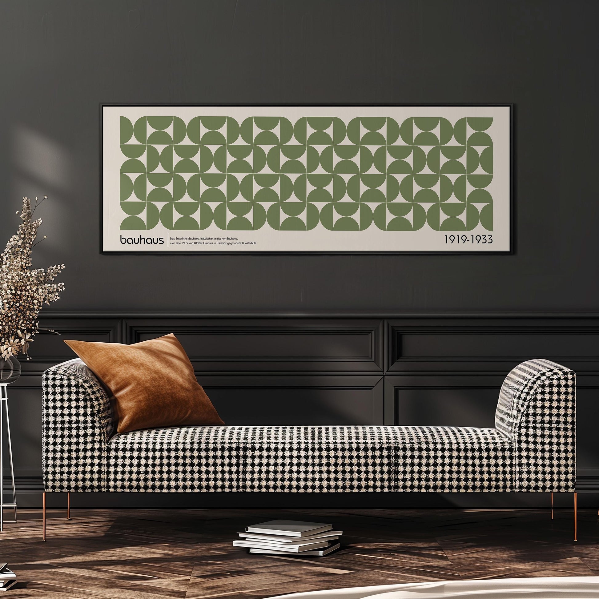 a modern living room with a black and white checkered sofa, a stack of books, and a framed poster on the wall.