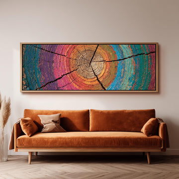 Rainbow tree ring long horizontal canvas print above a sofa in a living room