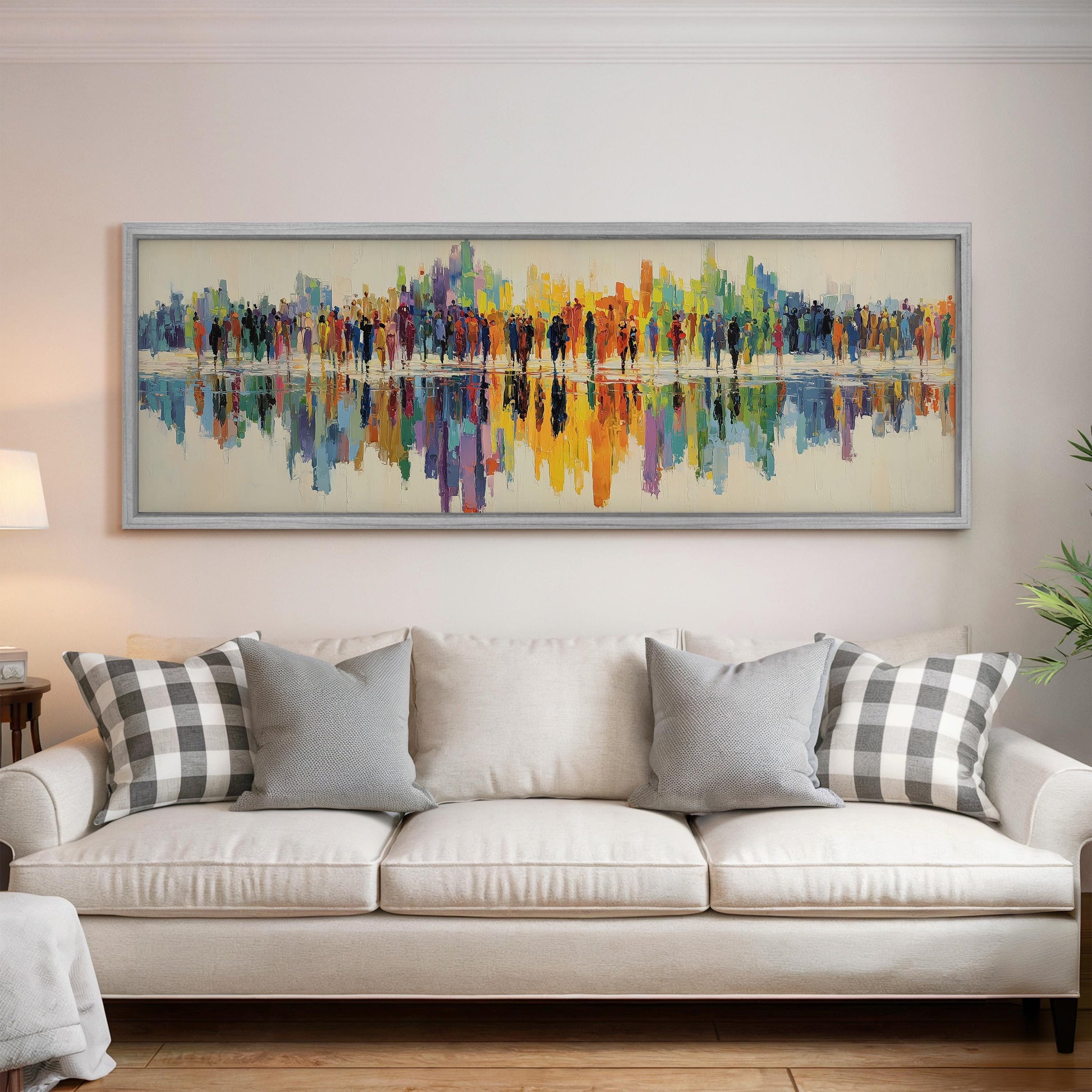 a large, colorful painting of a cityscape hanging on a wall above a white couch with gray and black plaid throw pillows.