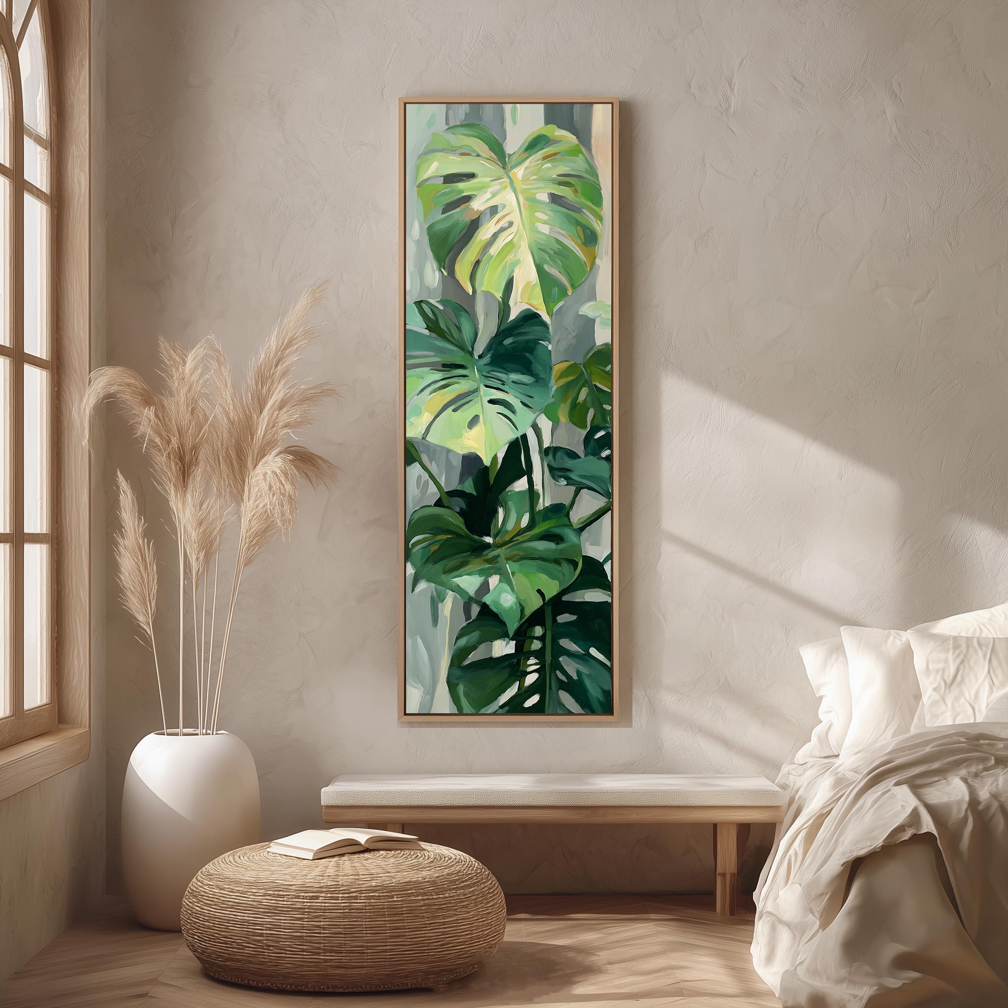 a large painting of tropical plants hanging on a wall in a room with a bed, a wicker ottoman, and a window.