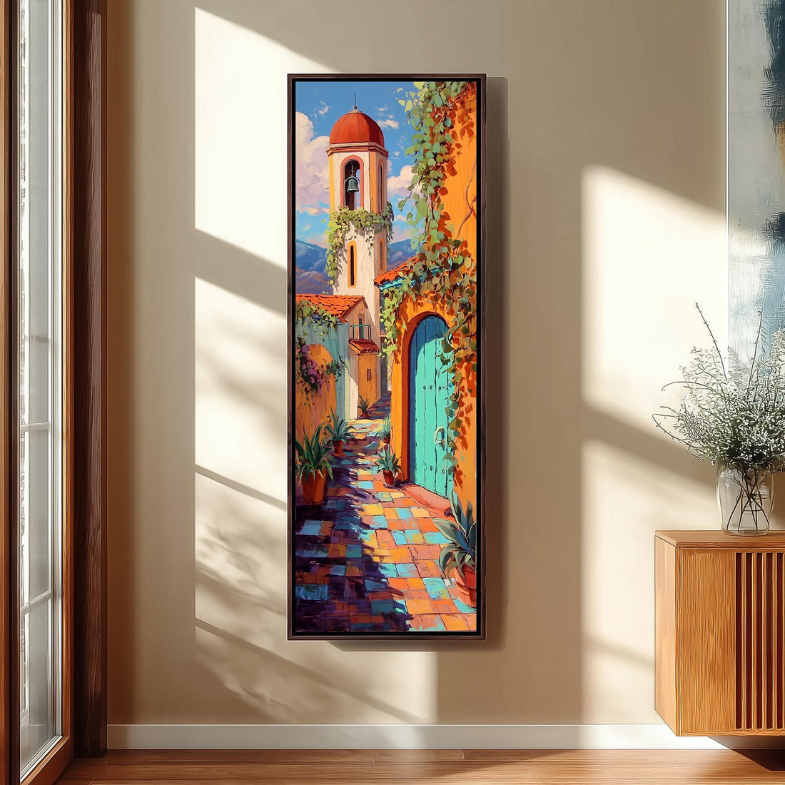 a large, colorful painting of a Spanish-style building with a bell tower, hanging on a wall in a room with a wooden floor and a window.