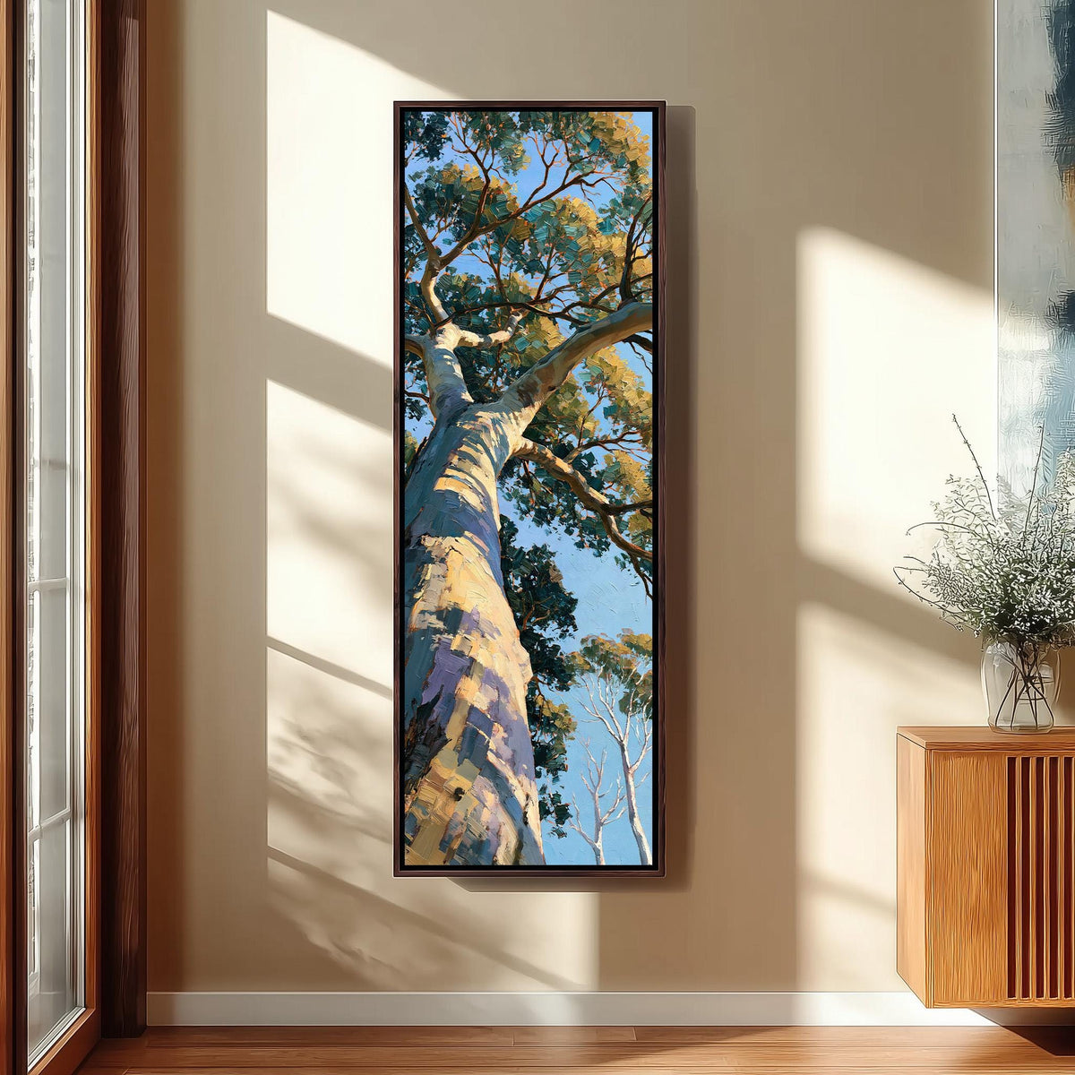 Gum tree trunk rising into a sunlit canopy tall skinny canvas print in a sunlit living space
