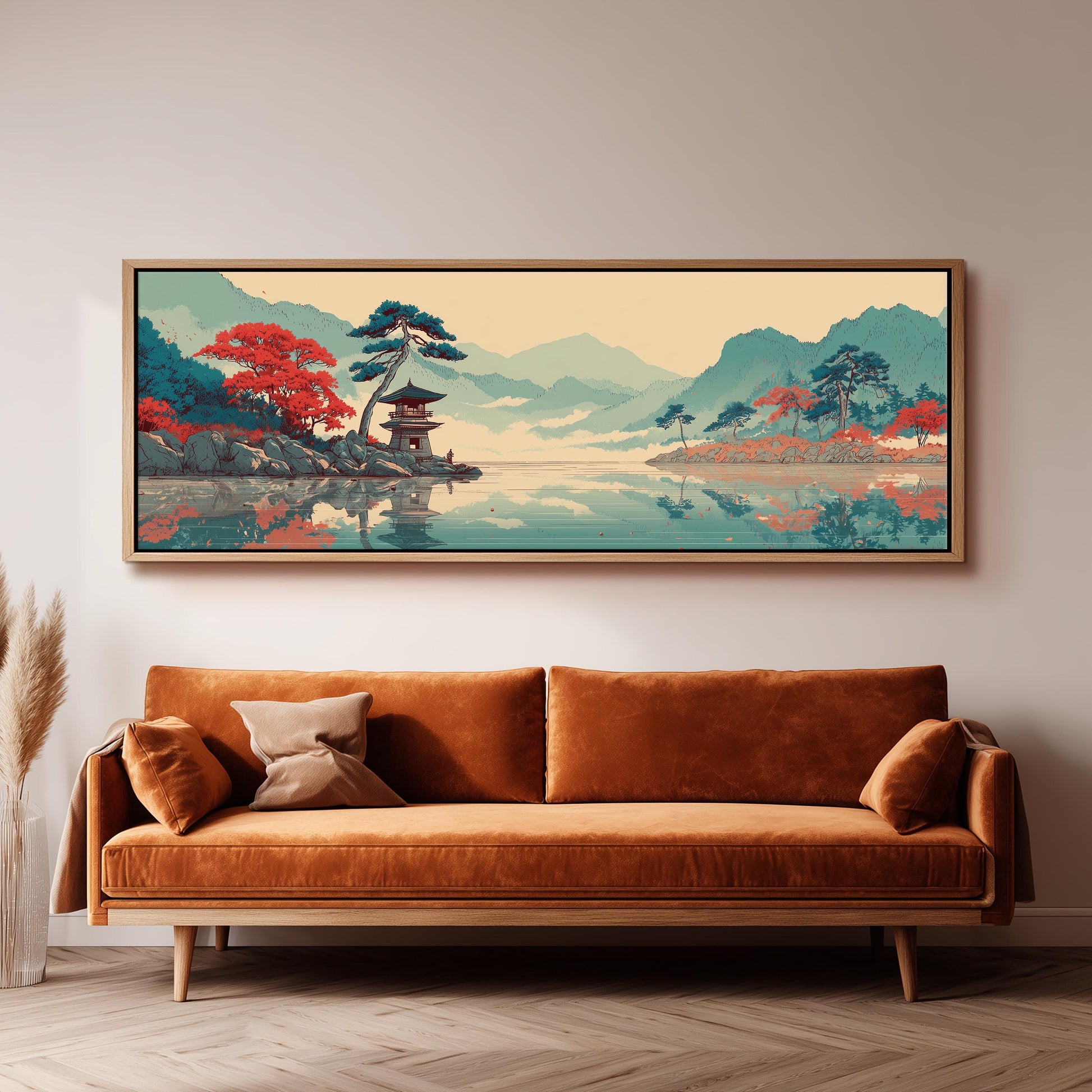 a large, framed painting of a serene landscape with mountains, trees, and a temple, hanging on a wall above a brown sofa.