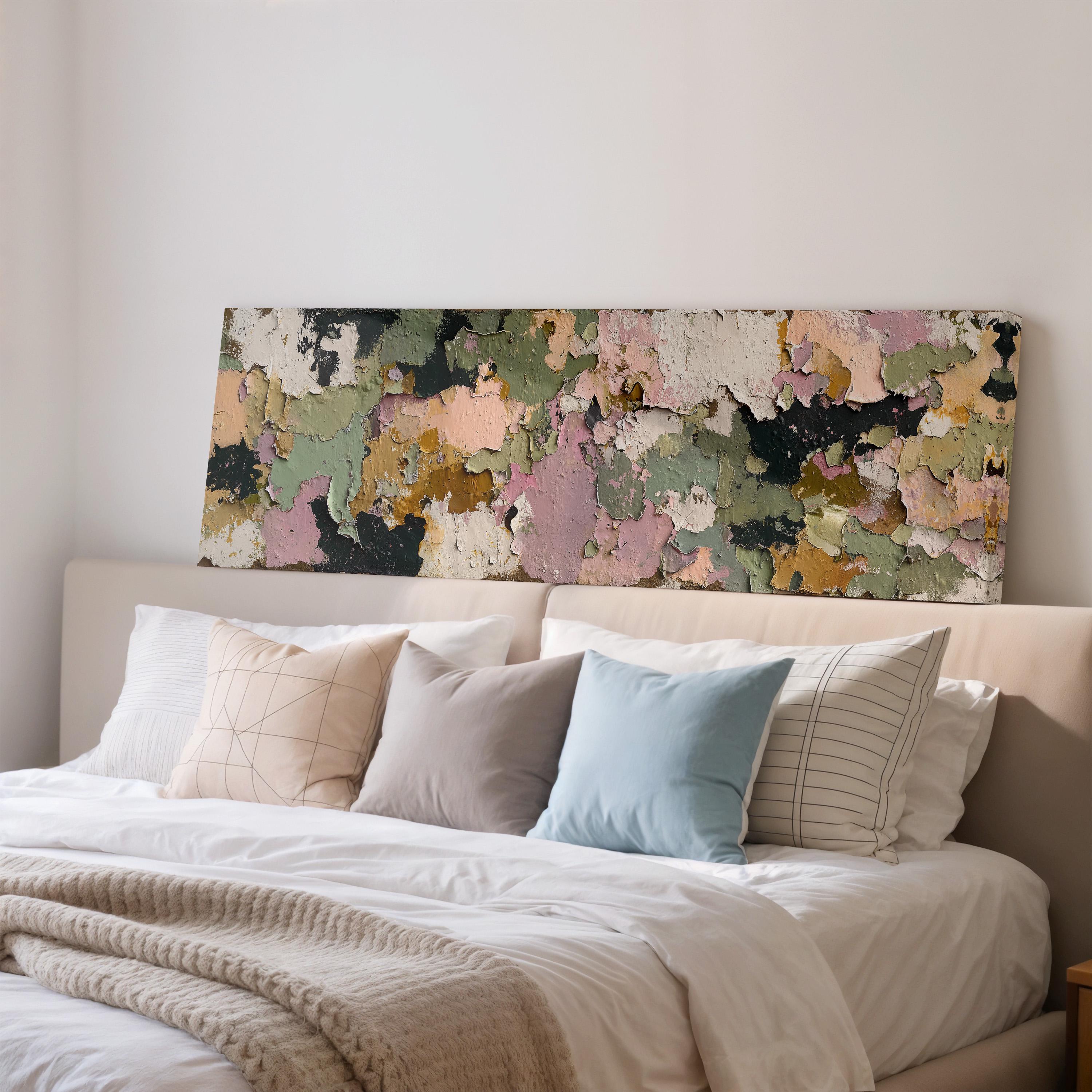 a bedroom with a bed covered in white sheets and pillows, and a large, colorful, textured painting or artwork hanging above the bed.