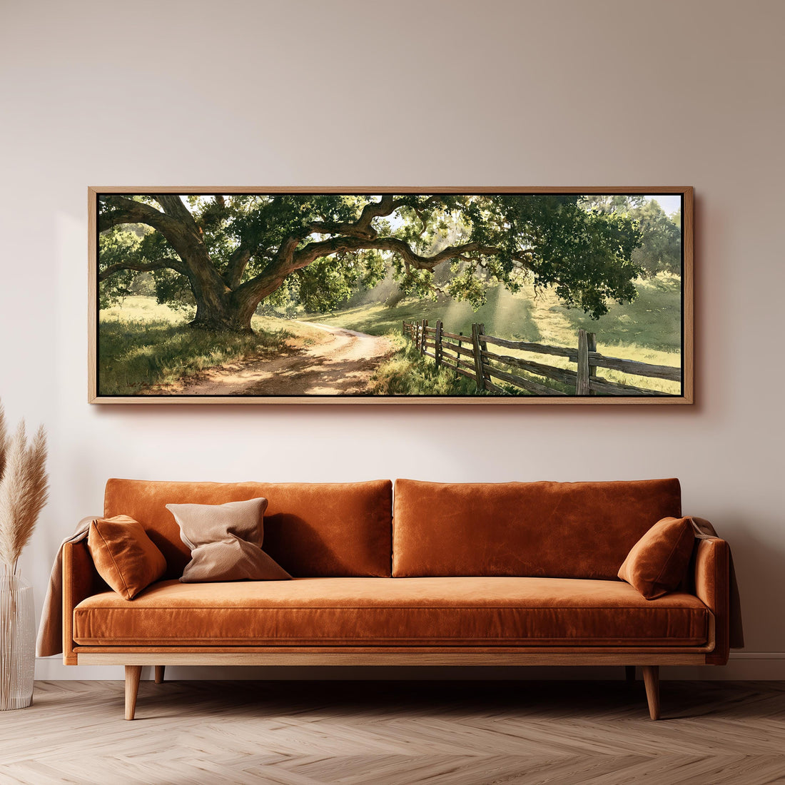 Sunlit country lane with oak trees and a wooden fence long horizontal canvas print above a sofa in a living room
