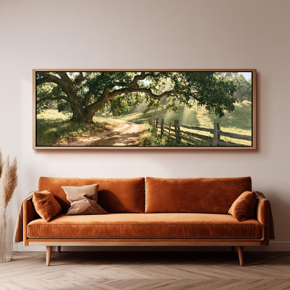 Sunlit country lane with oak trees and a wooden fence long horizontal canvas print above a sofa in a living room