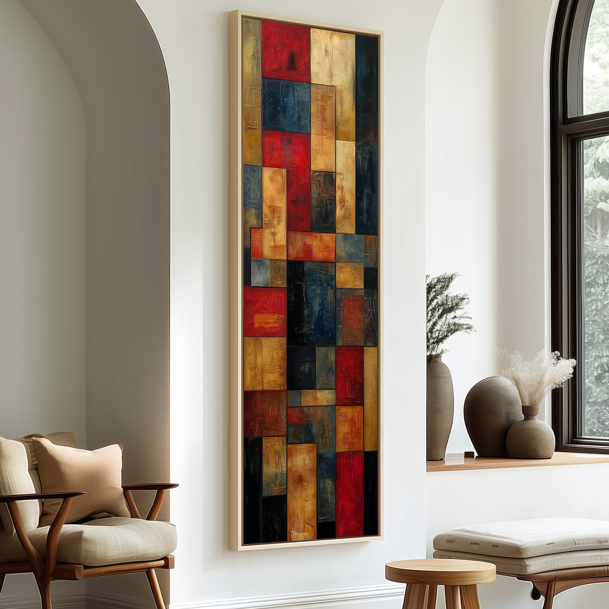 a modern living room with a large abstract painting hanging on the wall, a wooden chair, a small table, and a window with a plant on the sill.