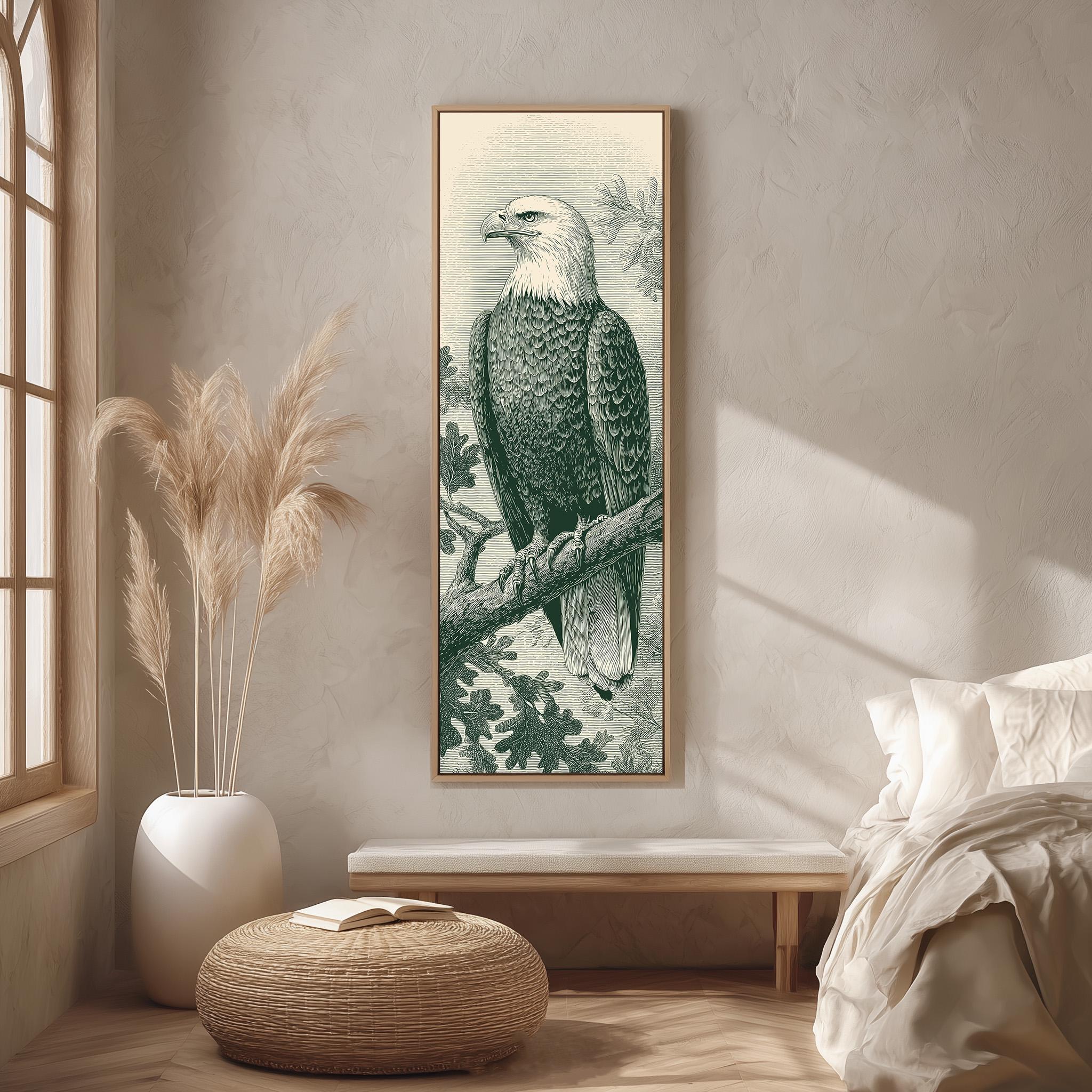 a large framed picture of a bald eagle perched on a branch, hanging on a wall in a room with a wooden floor and a white bed in the background.