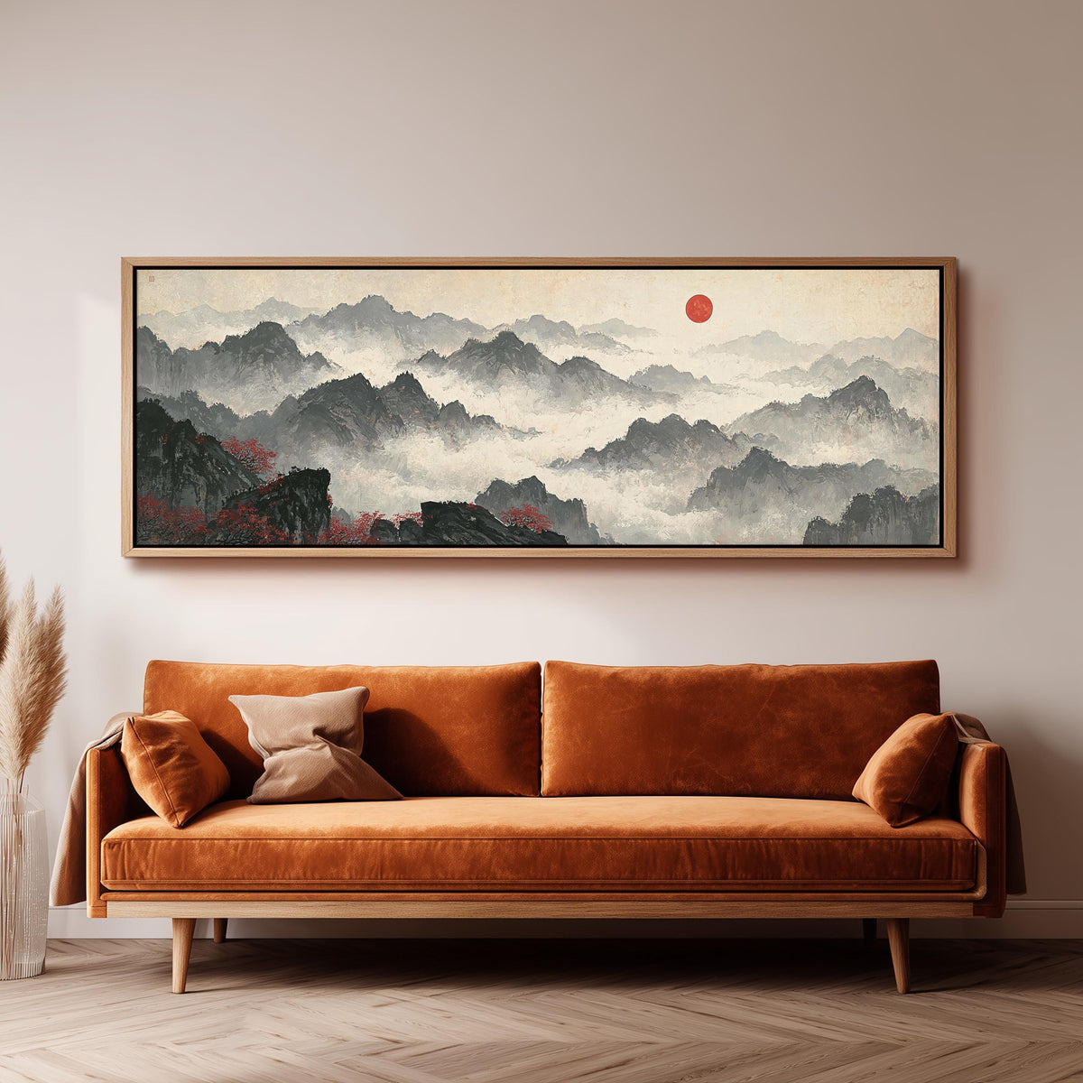 Misty ink mountains under a red sun panoramic canvas print above a sofa in a living room
