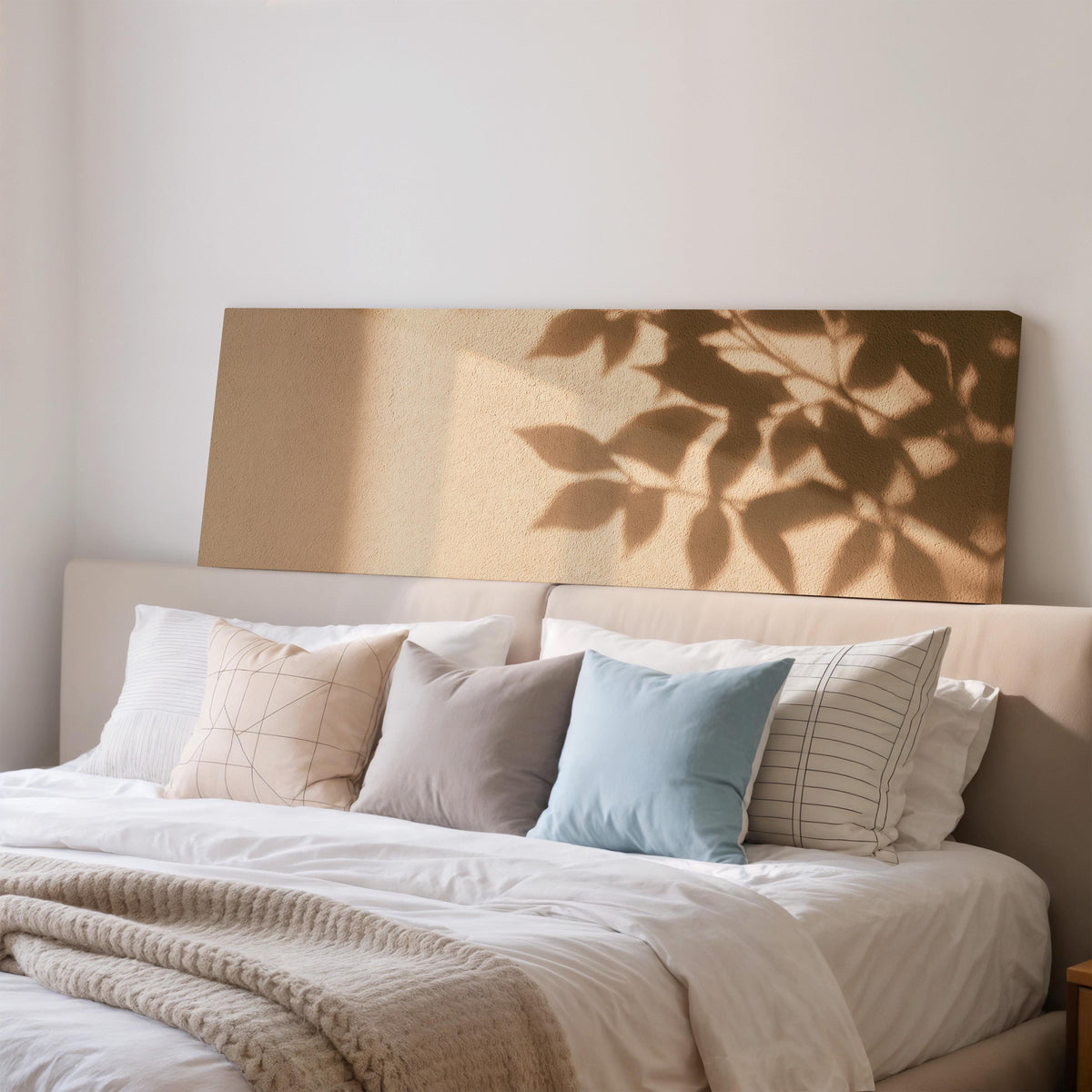 Leaf shadows on a golden plaster wall wide panoramic canvas print above a bed in a bedroom