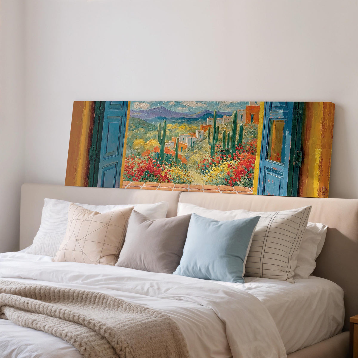 Cactus courtyard seen through blue doors wide panoramic canvas print above a bed in a bedroom