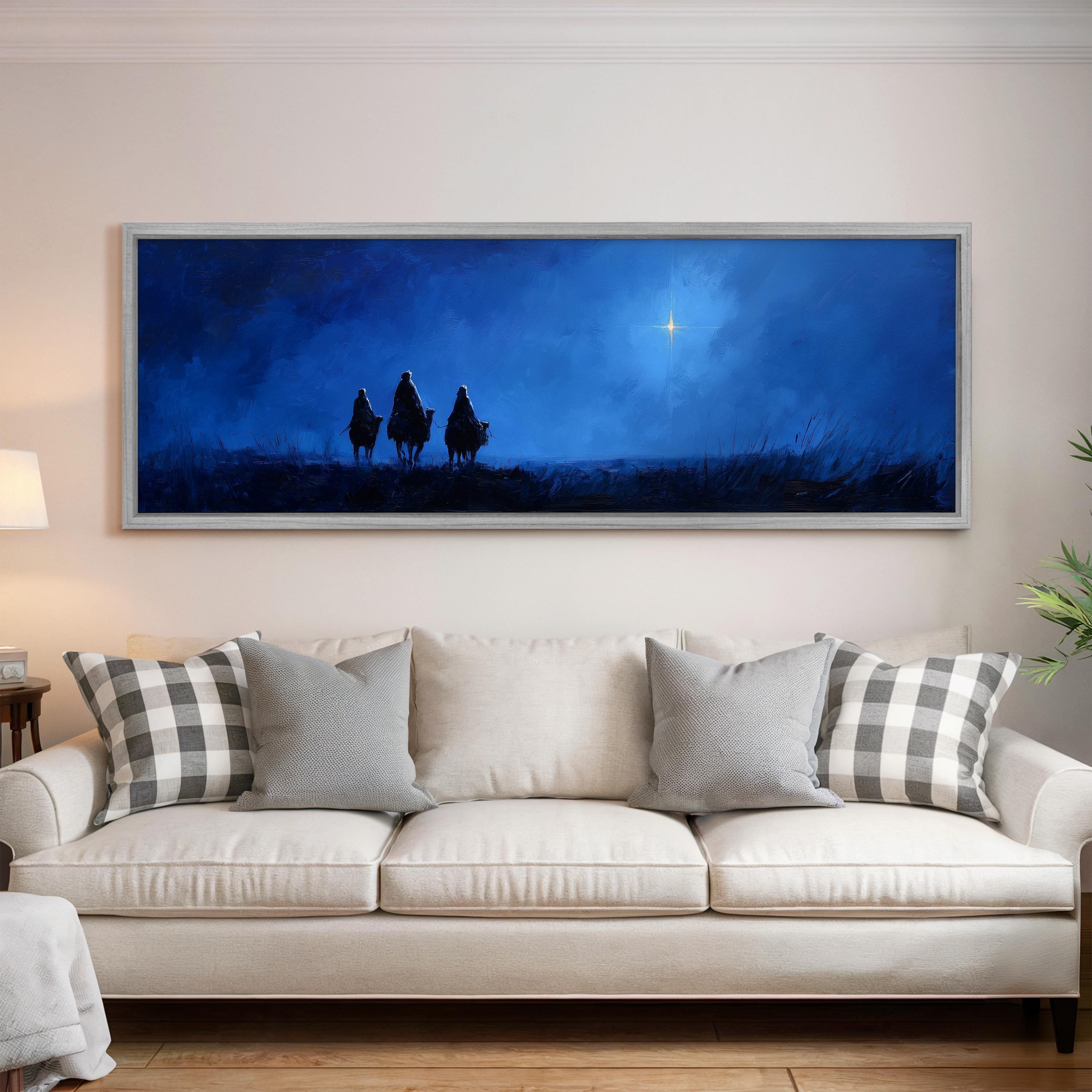 a large, framed painting of three figures on horseback against a night sky backdrop, with a bright star visible in the sky.