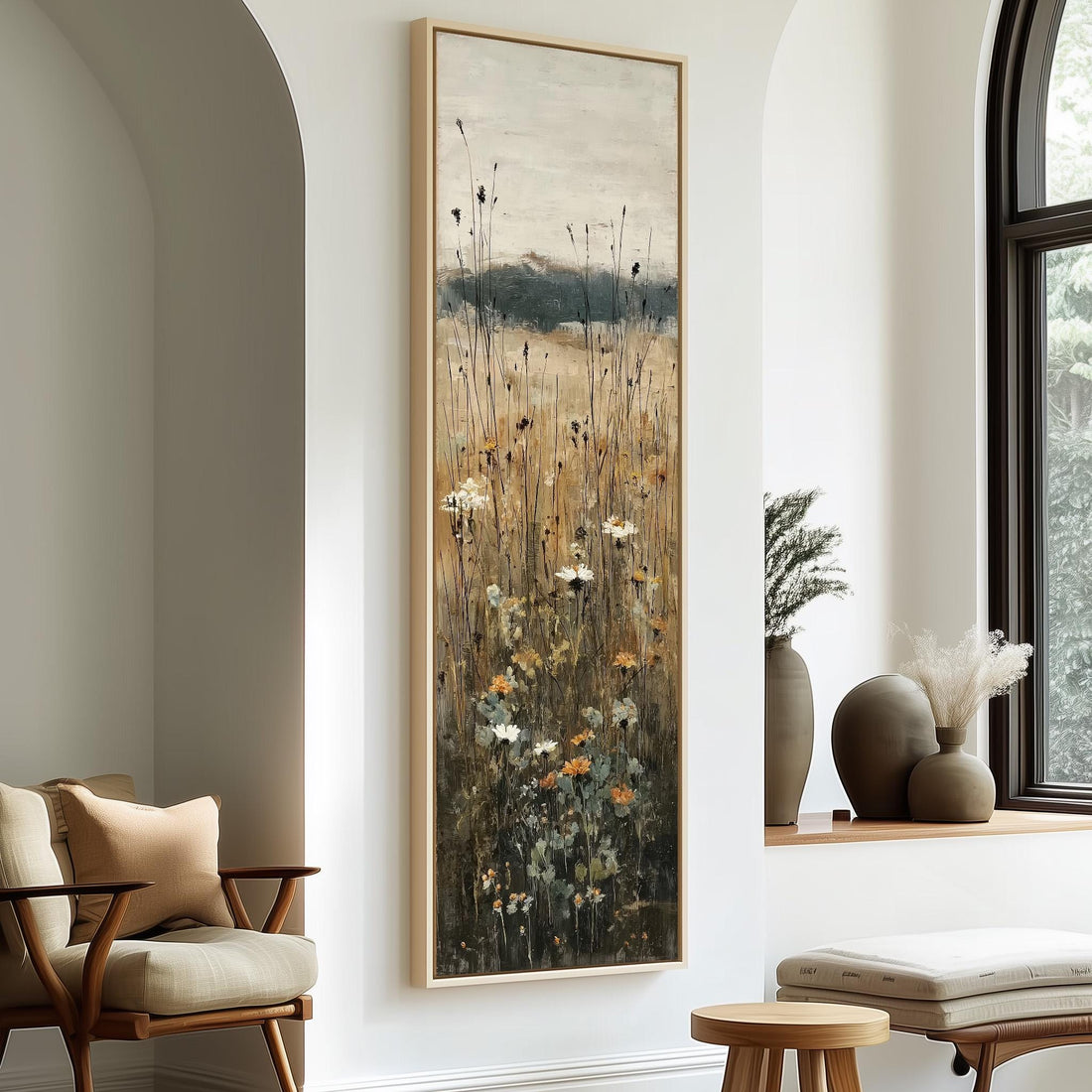 a large painting of a field with tall grass and wildflowers hanging on a wall in a room with wooden furniture.