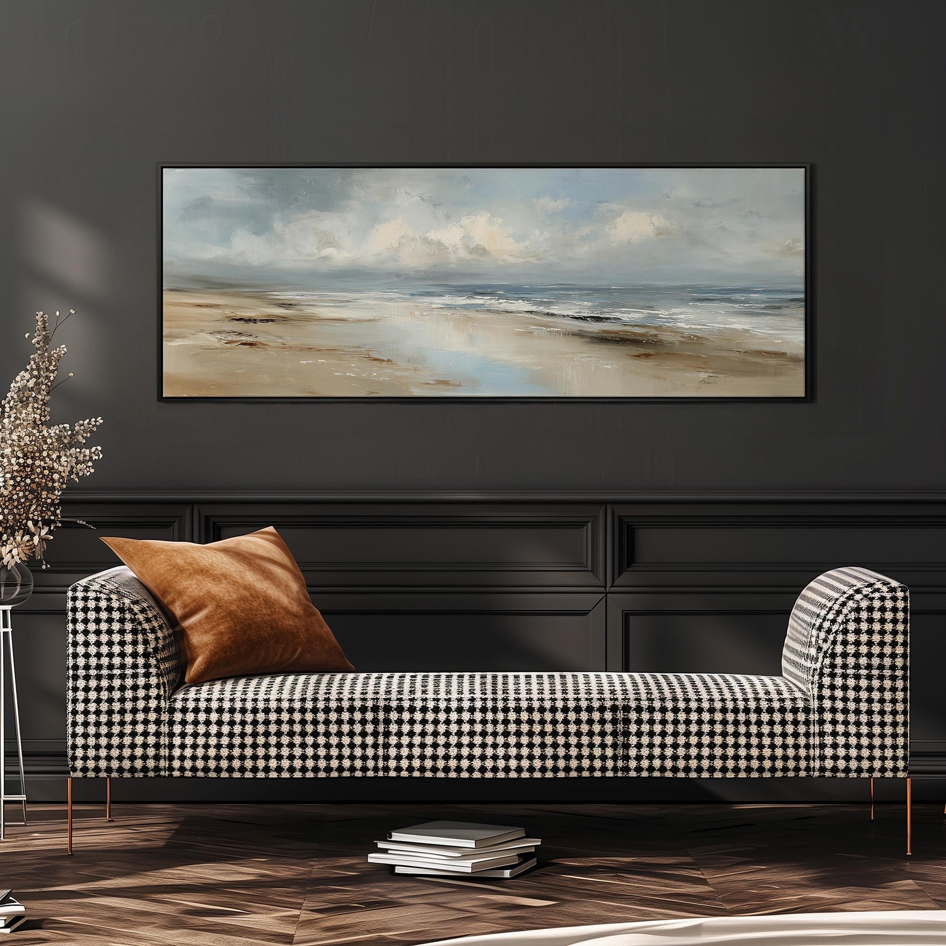 a black and white checkered sofa with a brown throw pillow, positioned in front of a large painting depicting a beach scene with a cloudy sky.