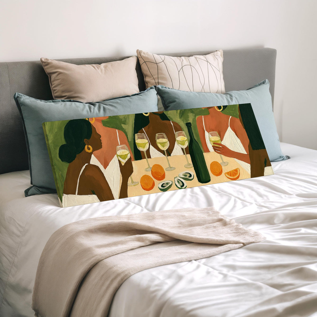Friends toasting with white wine wide panoramic canvas print laid on a bed to show its size