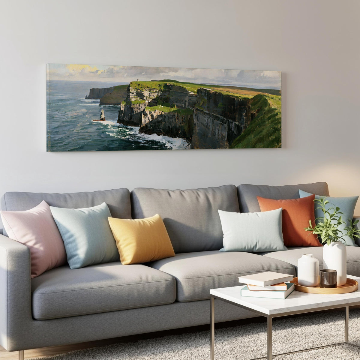 Sunlit sea cliffs with a sea stack panoramic canvas print above a grey sofa in a living room