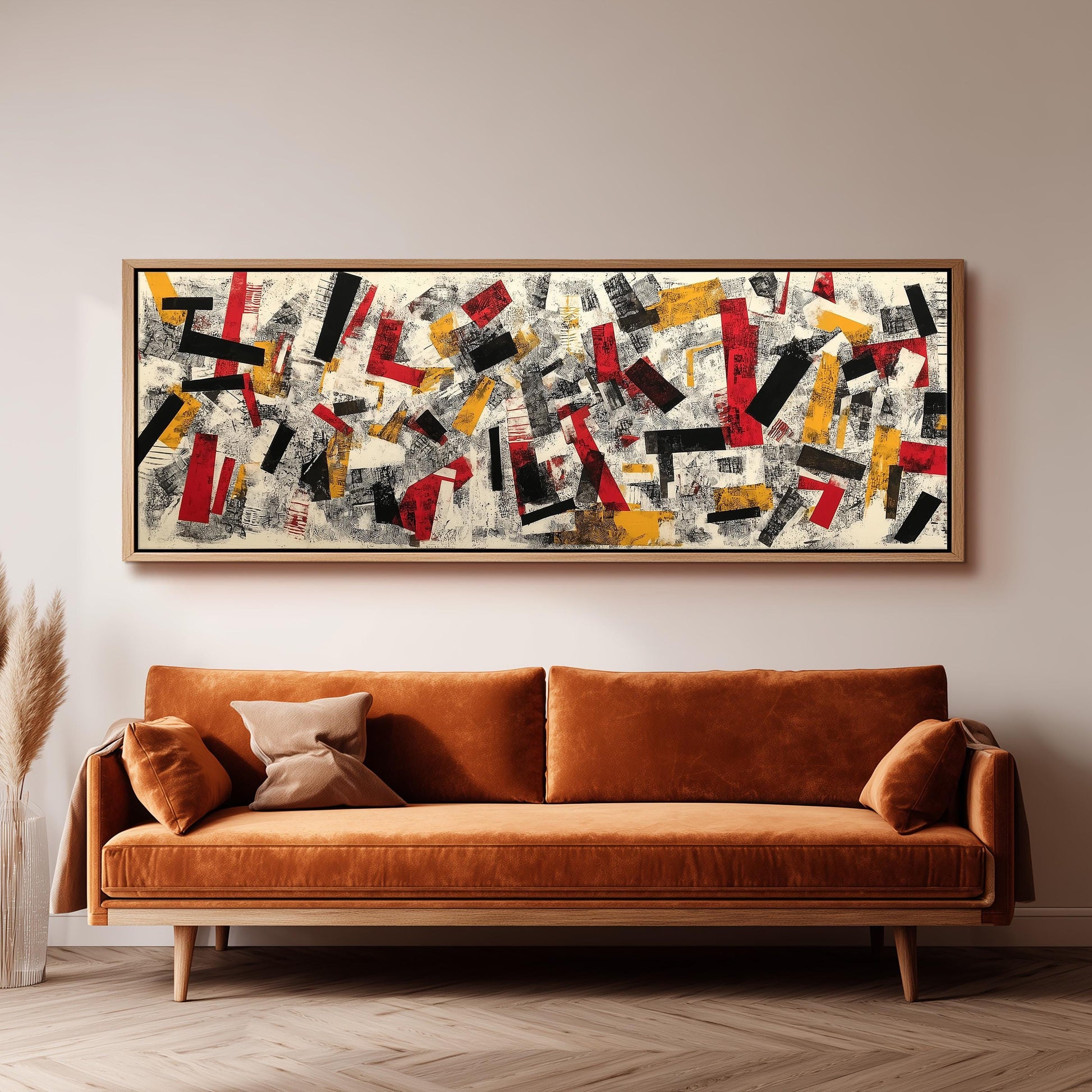 a large abstract painting hanging on a wall above a brown sofa.