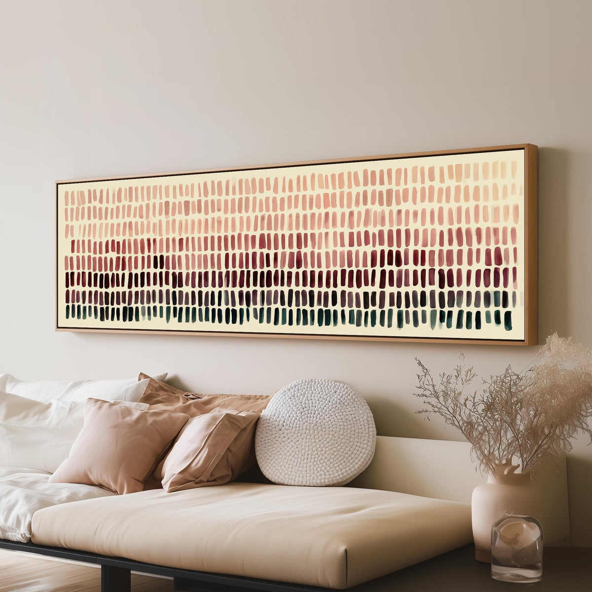 Brushmarks fading from blush to deep maroon panoramic canvas print above a sofa in a living room