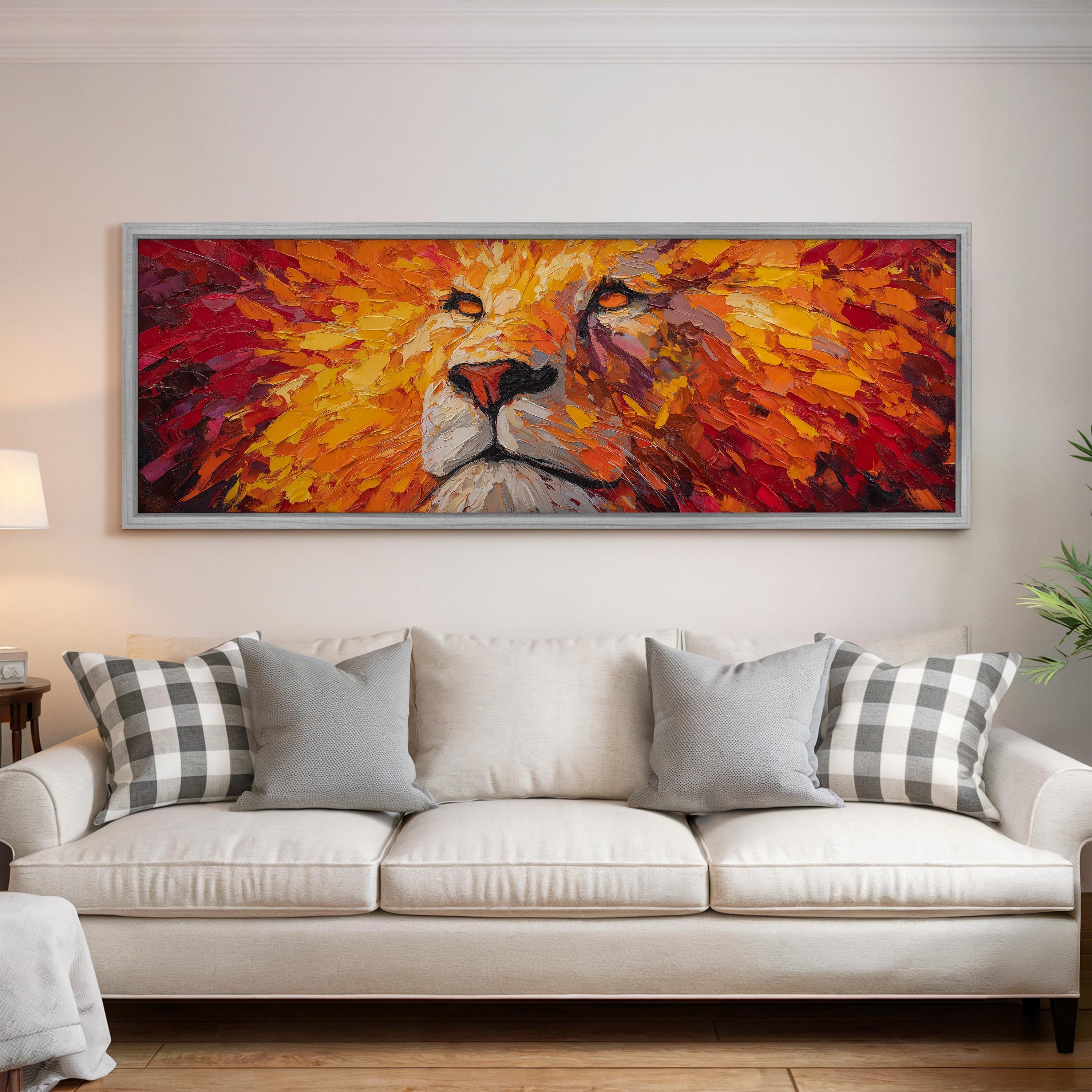 a large, colorful painting of a lion's face hanging on a wall above a white couch in a living room.