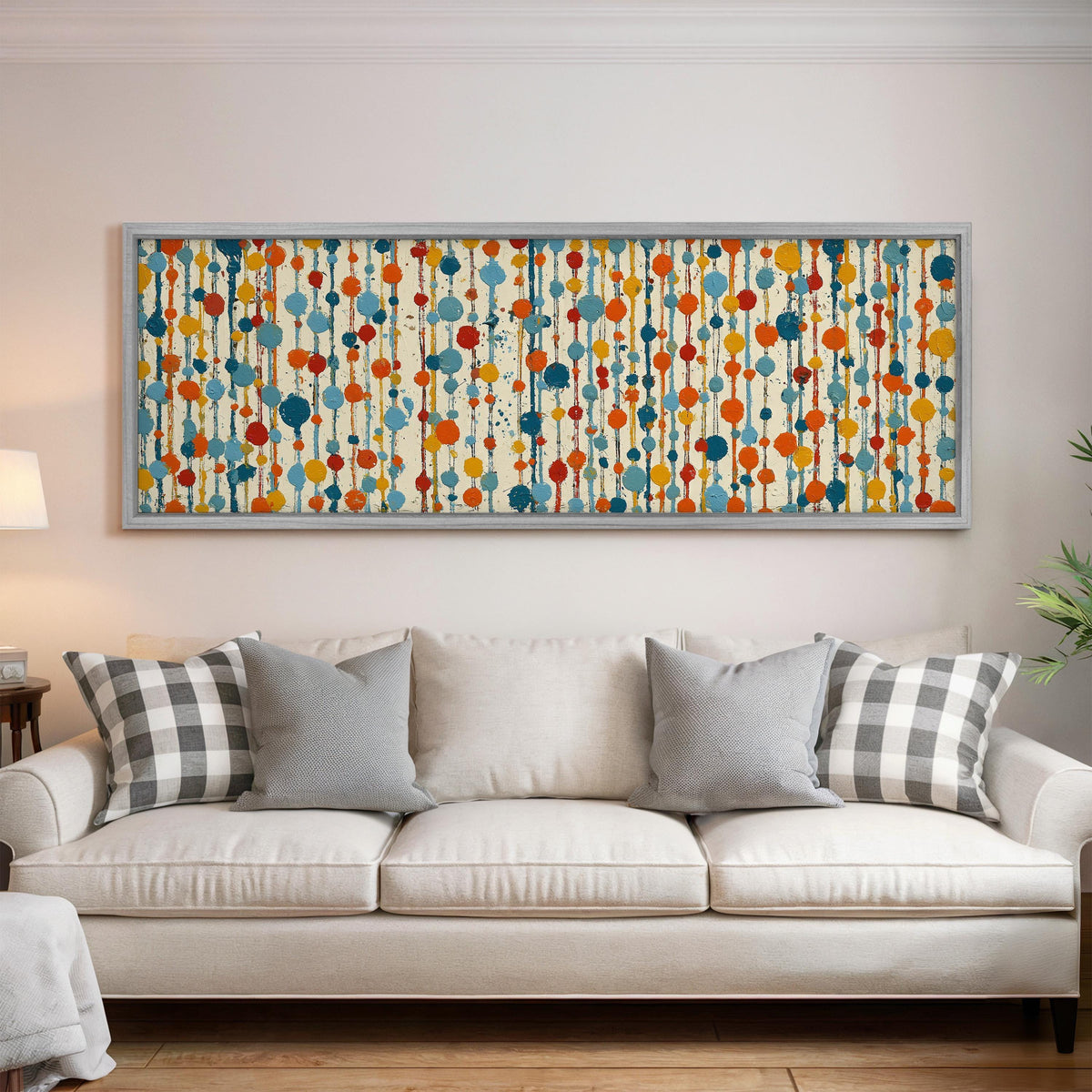 Strings of colorful polka dot blooms panoramic canvas print above a white sofa in a bright living room