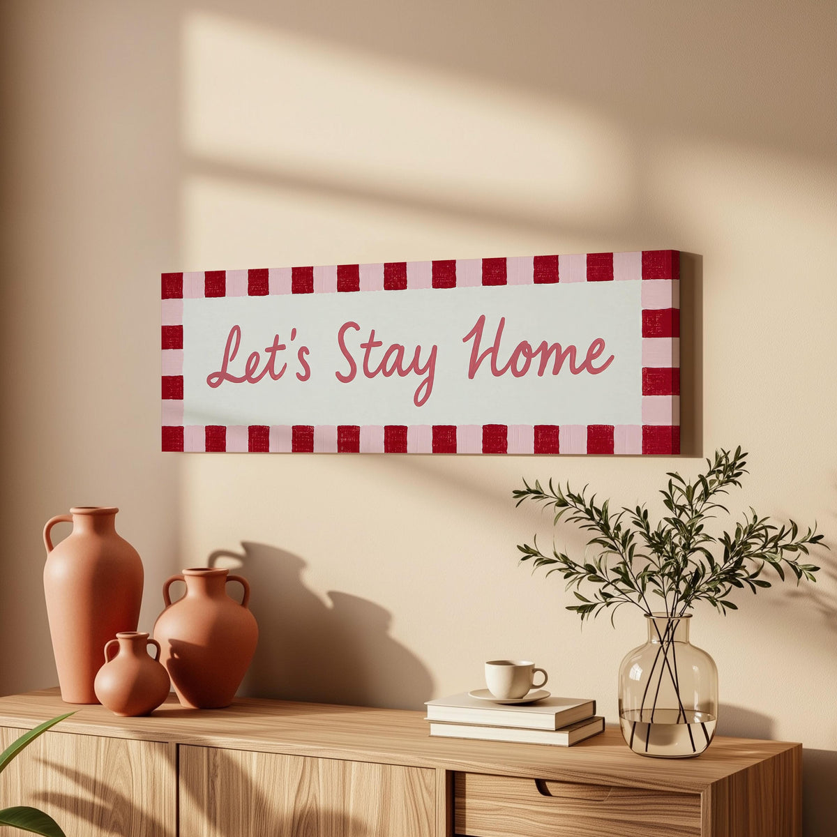 Let's stay home sign with a red checked border long horizontal canvas print above a wooden sideboard