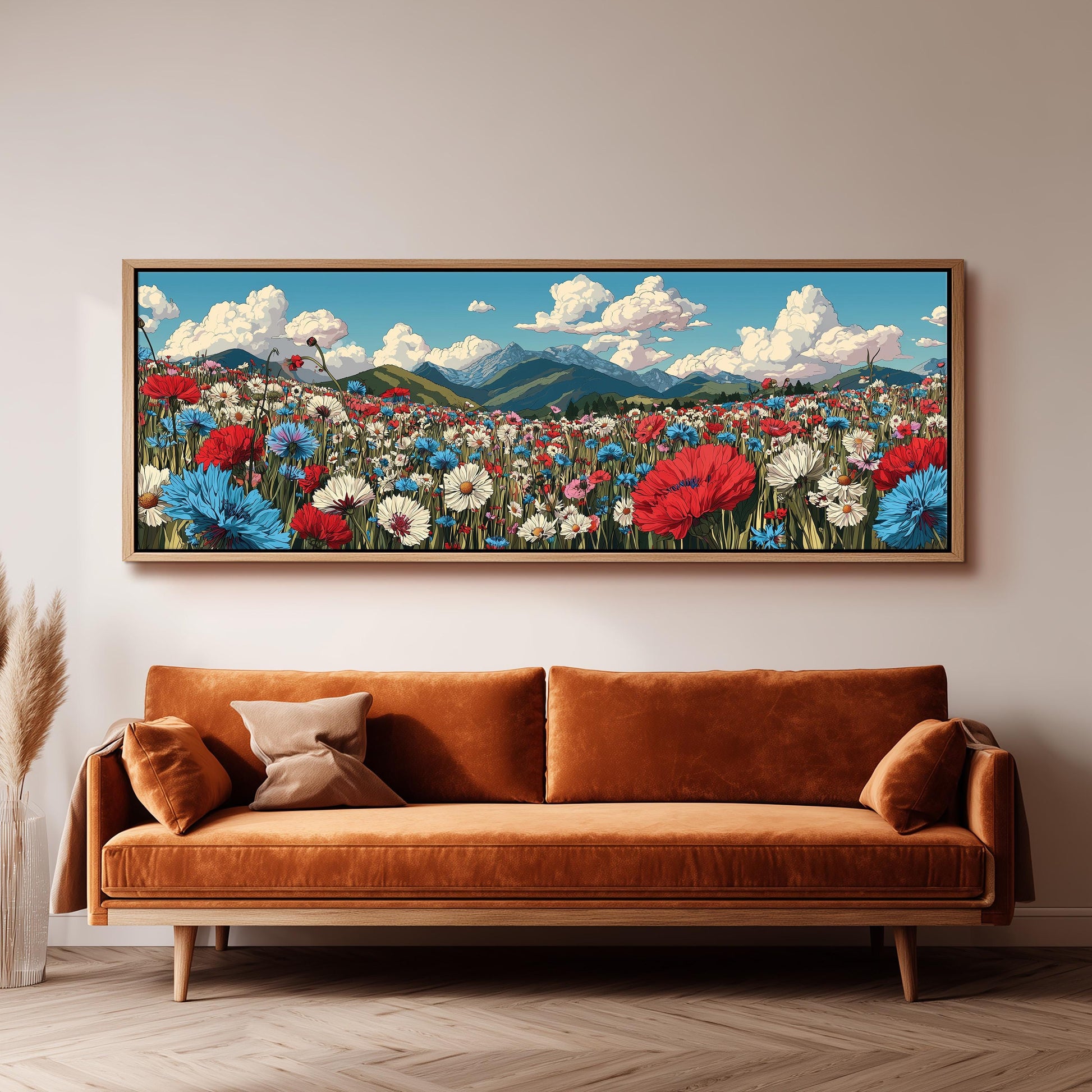 a large, framed painting of a vibrant field of flowers hanging on a wall above a brown sofa.