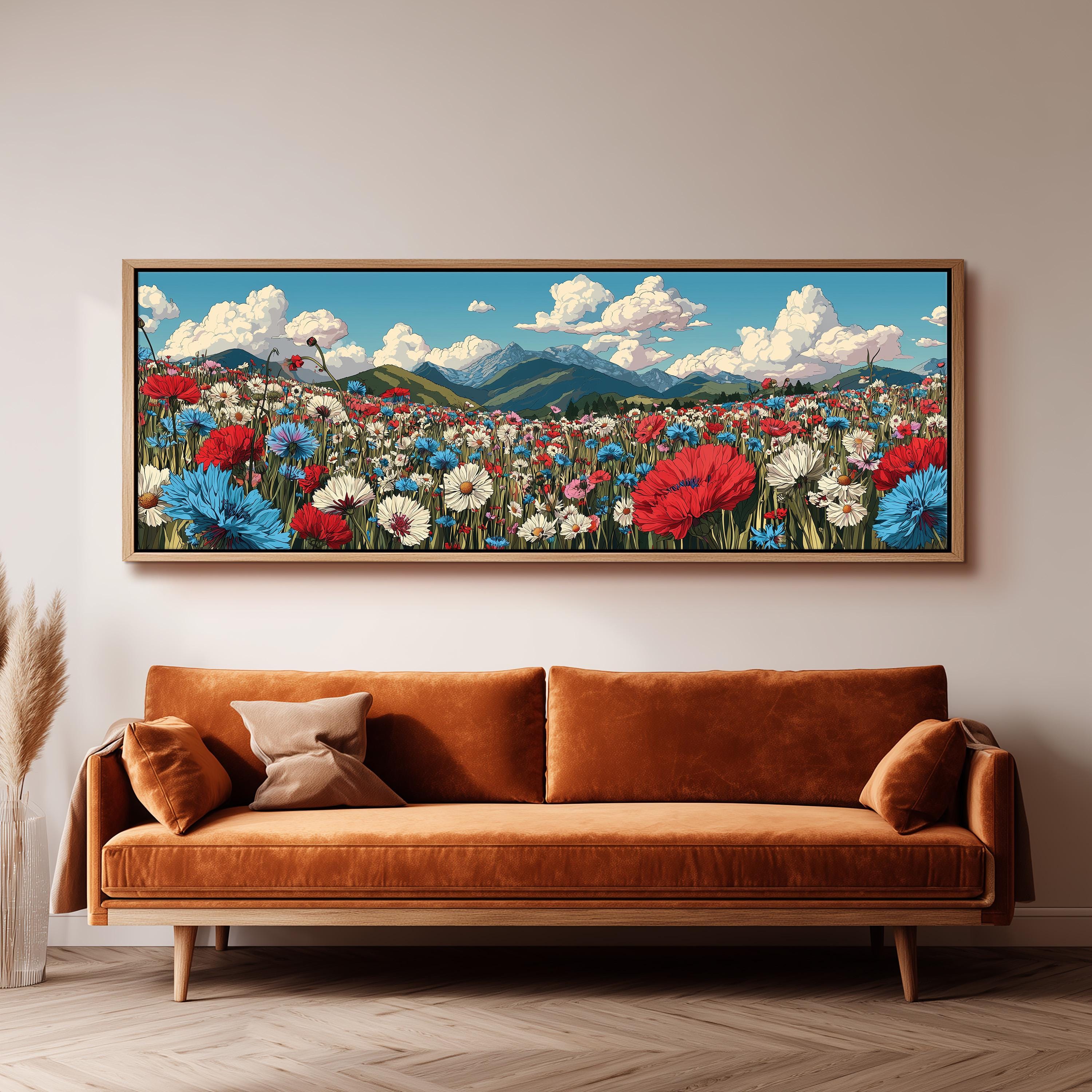 a large, framed painting of a vibrant field of flowers hanging on a wall above a brown sofa.