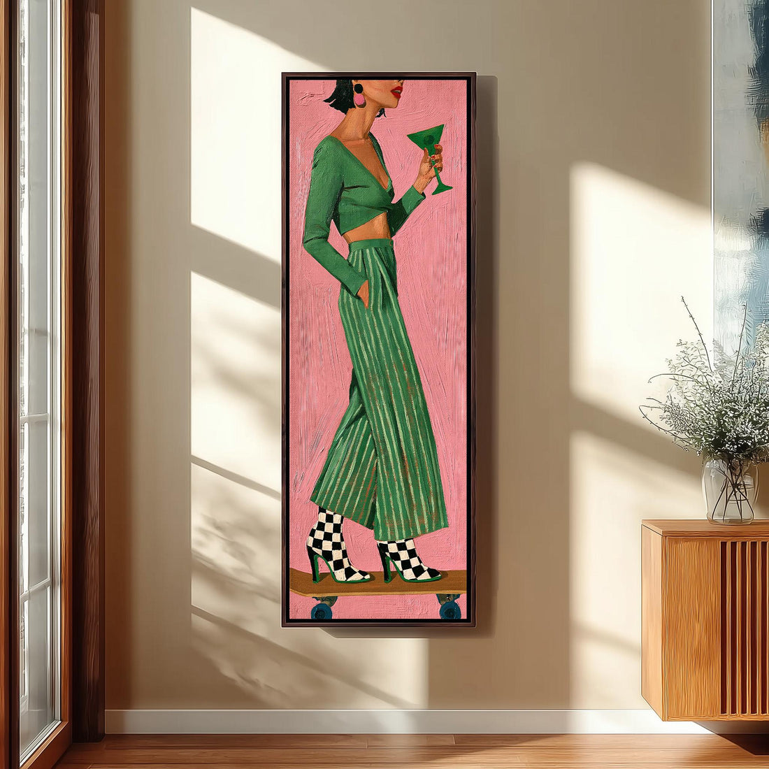 Woman in a green striped suit holding a cocktail long vertical canvas print in a sunlit living space