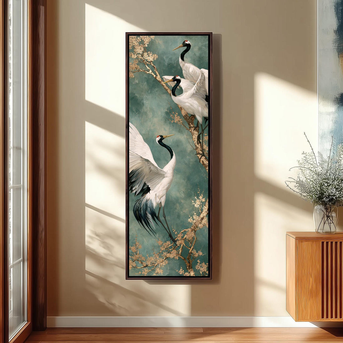 Cranes perched on a blossom branch long vertical canvas print in a sunlit living space
