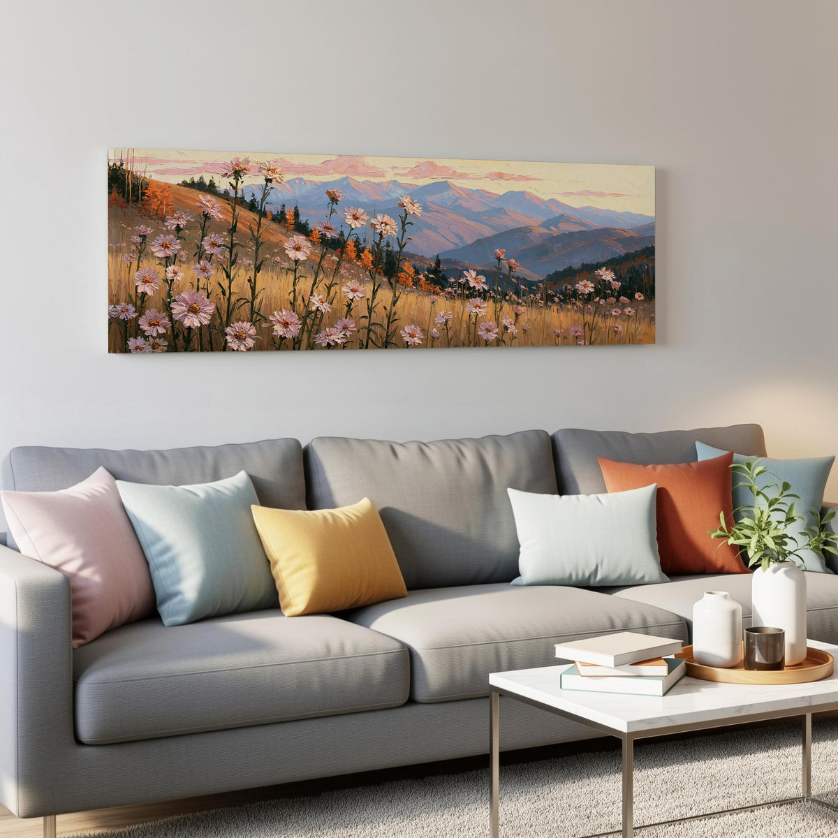 Wildflower meadow with mountains panoramic canvas print above a grey sofa in a living room