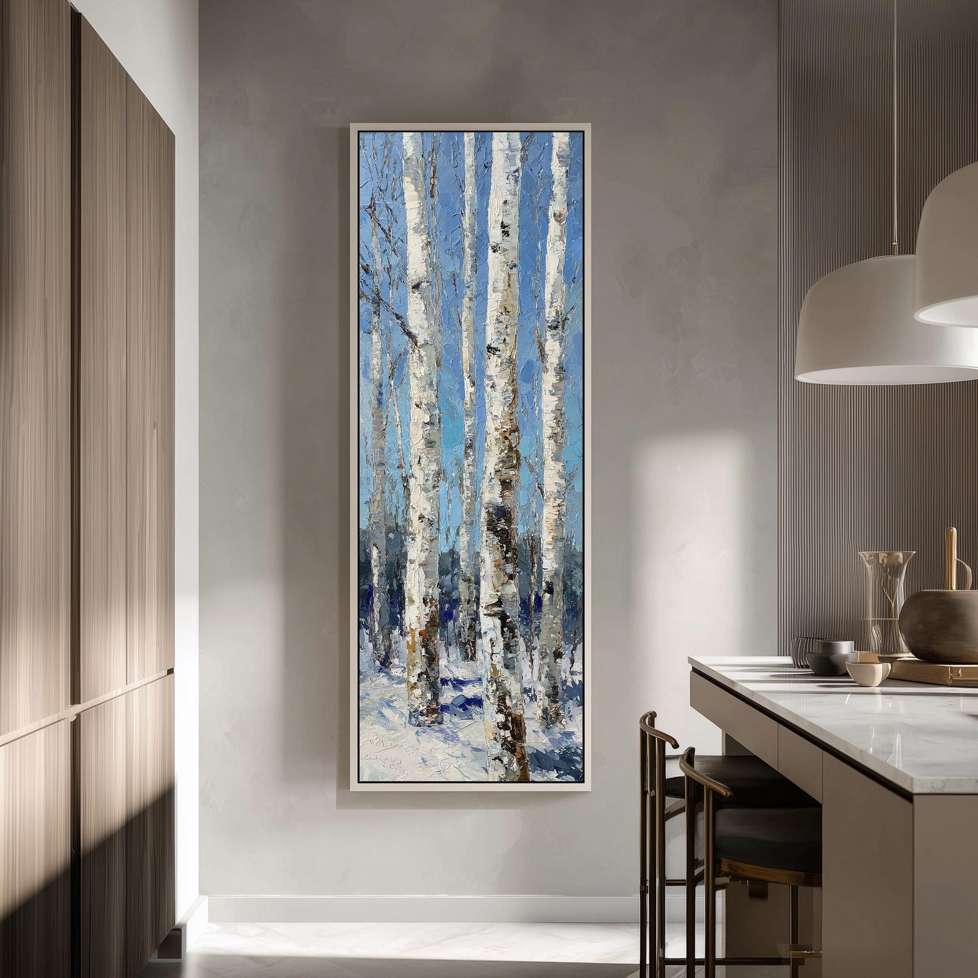 a large painting of birch trees with white bark hanging on a wall in a modern kitchen.