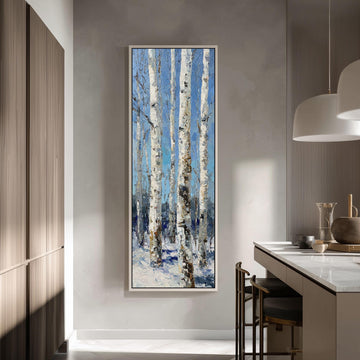 a large painting of birch trees with white bark hanging on a wall in a modern kitchen.