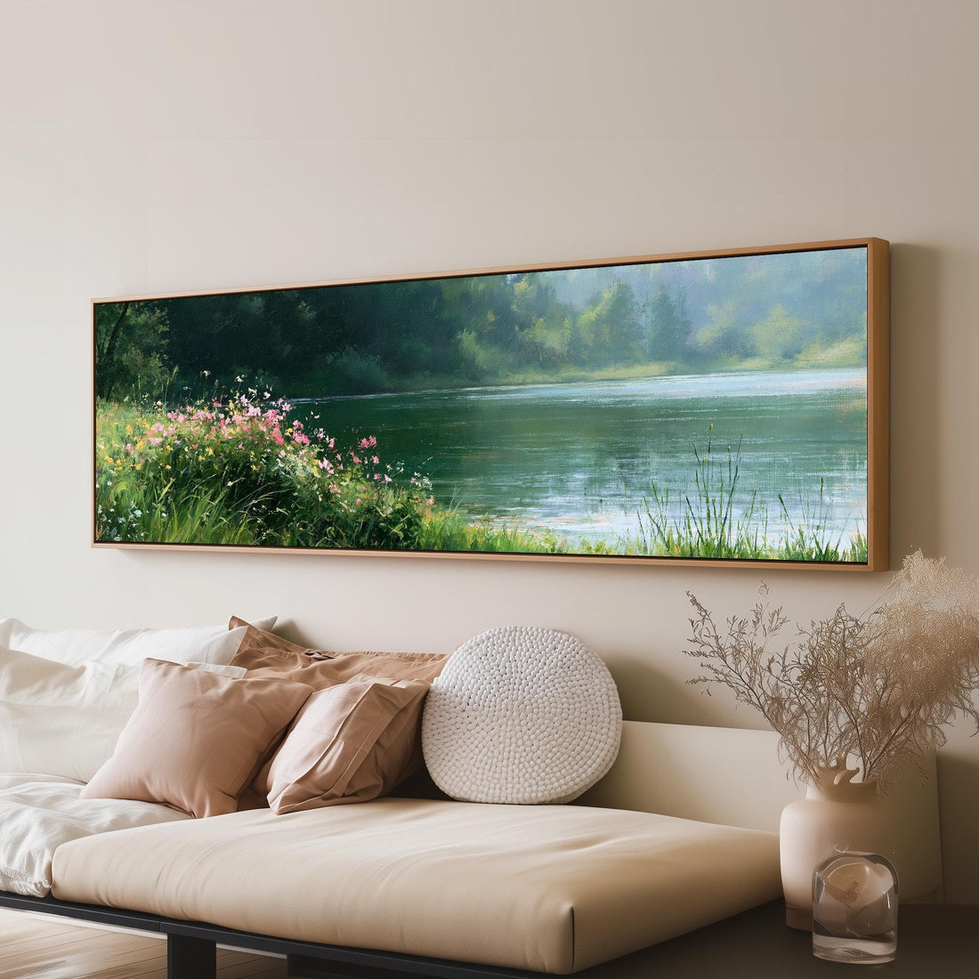 Pink wildflowers on a green lakeshore long horizontal canvas print above a sofa in a living room