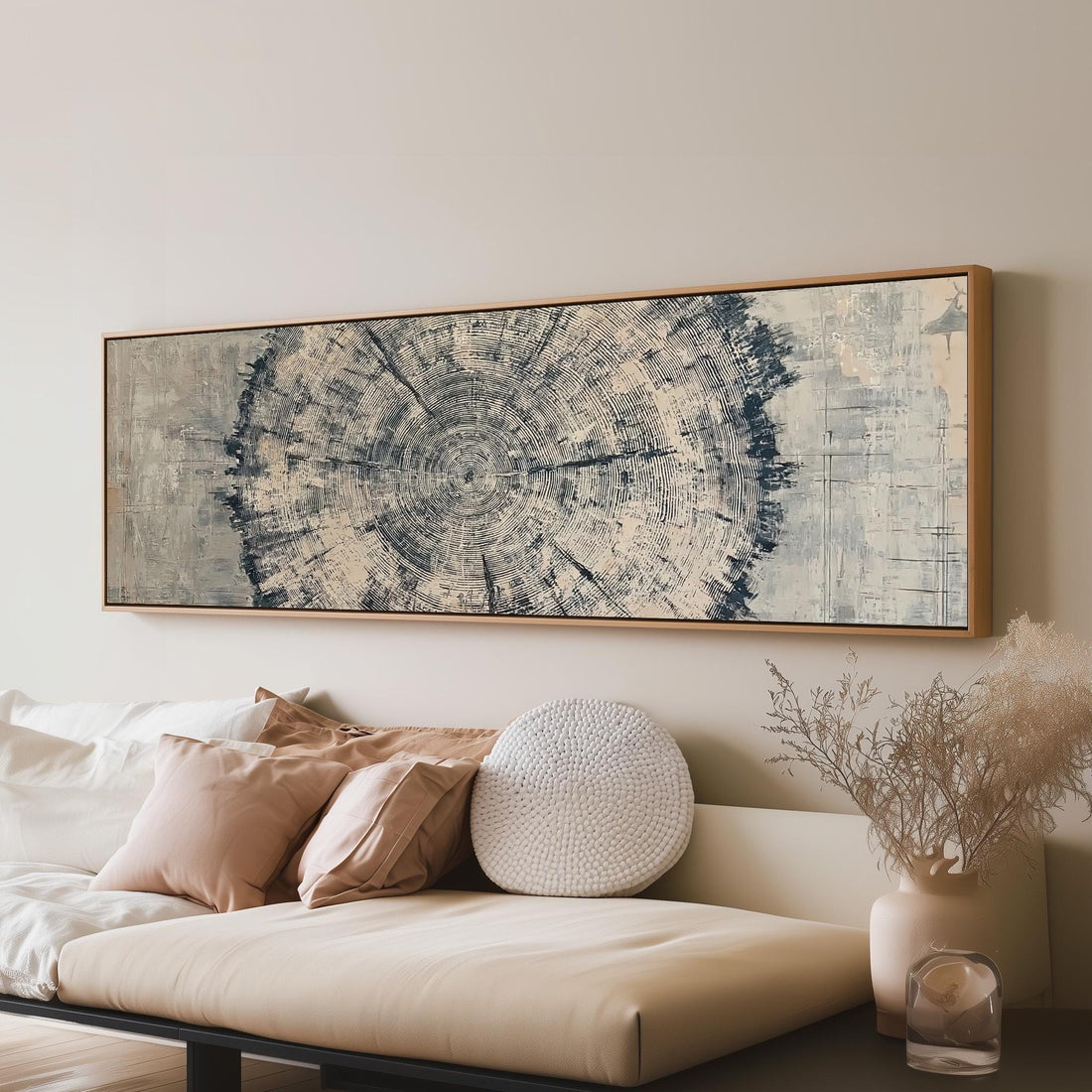 Navy ink tree ring long horizontal canvas print above a sofa in a living room