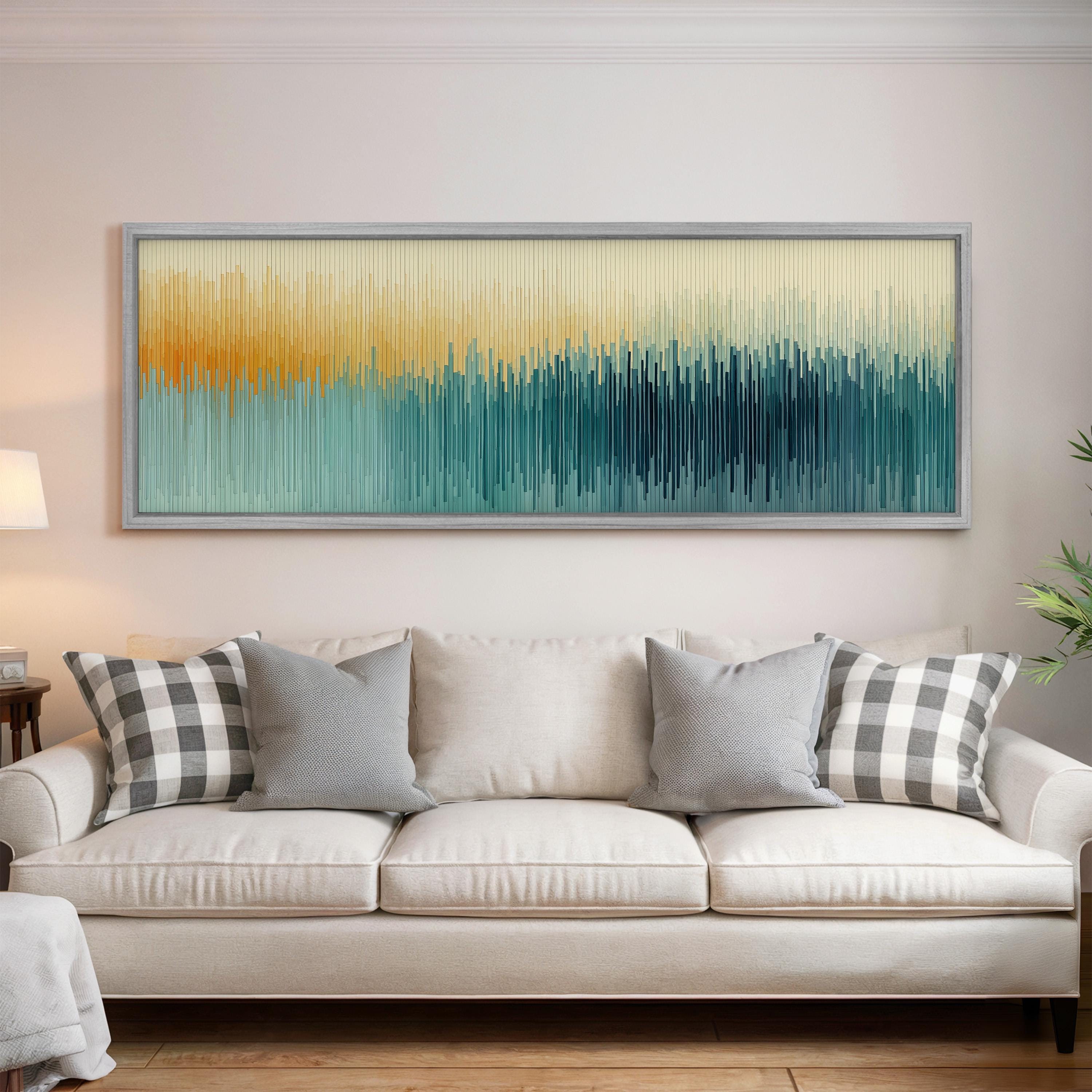 a large, colorful abstract painting hanging on a wall above a white couch with gray and black plaid throw pillows.